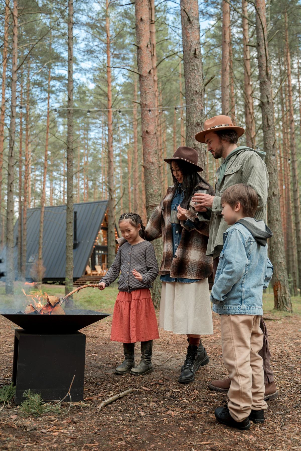 A family gathered around a campfire in the woods