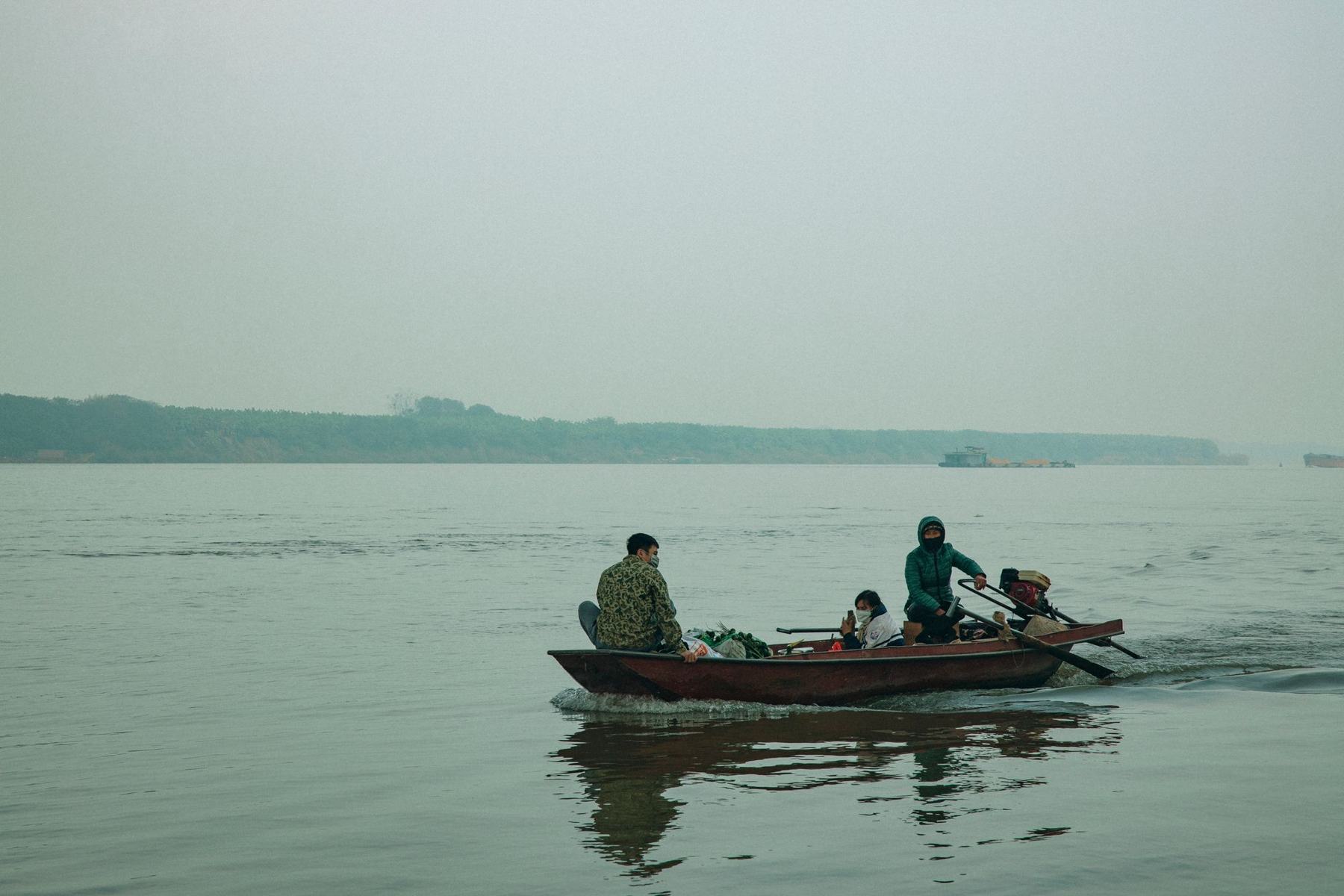 A family boat on a misty lake at dawn